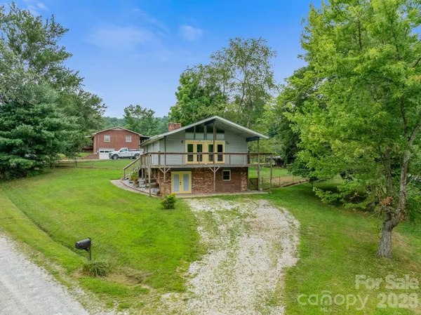 a house with green field in front of it