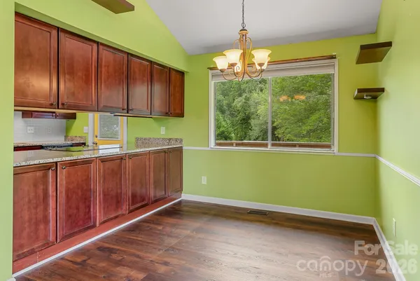 a kitchen with a window and cabinets