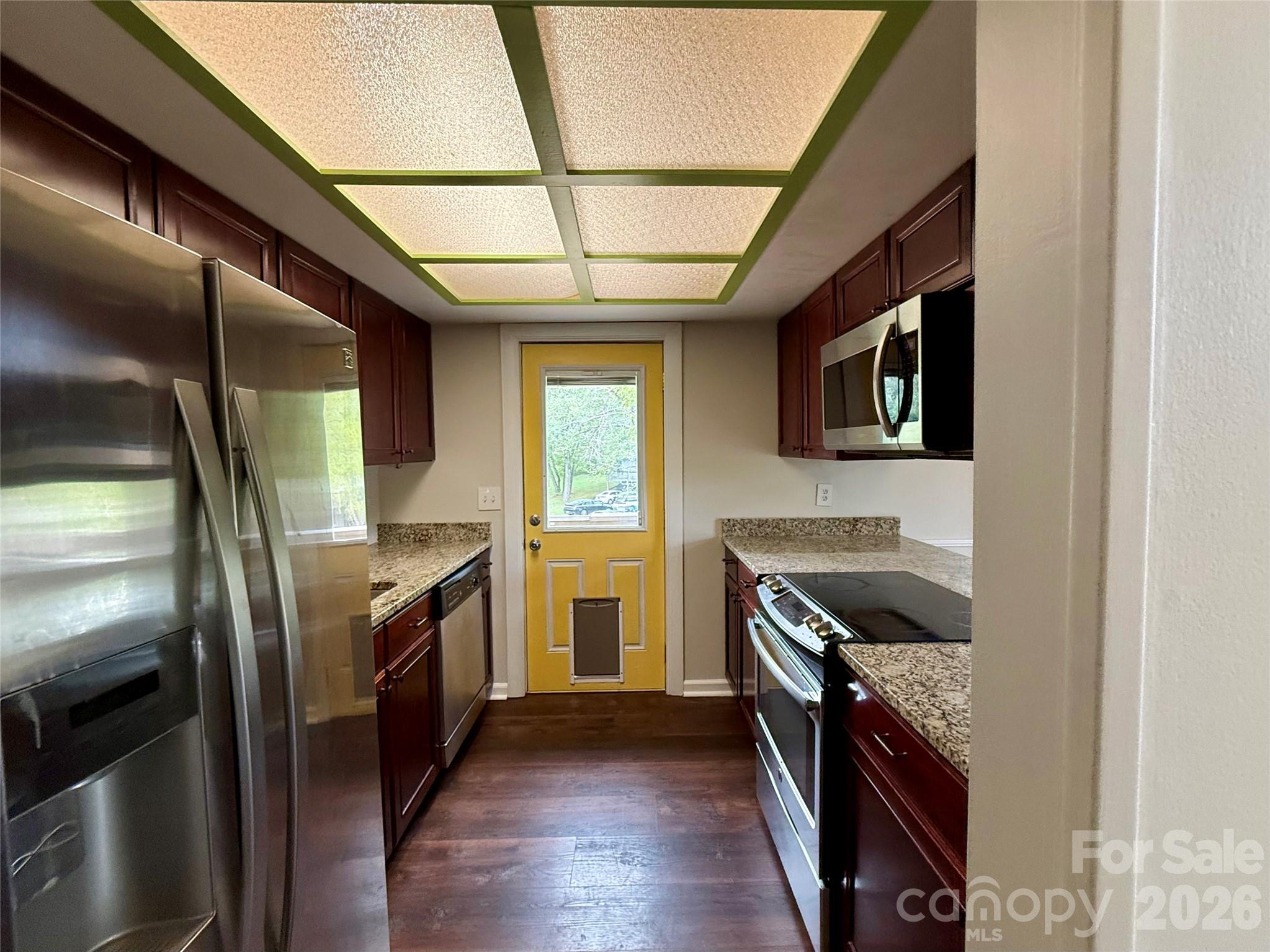 18 Briar Fork Way, Unit 4 Fletcher, NC 28732 - Photo 10 of 36 a kitchen with stainless steel appliances granite countertop a stove a sink and a refrigerator