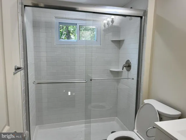 a bathroom with a shower and toilet