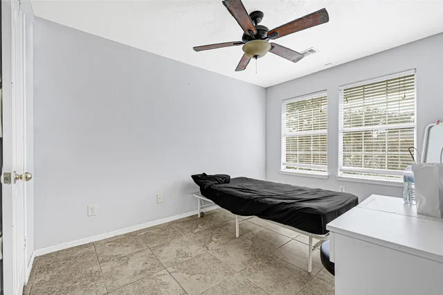 a bath room with a bed and a window