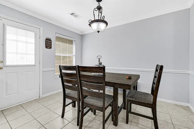 a view of a dining room with furniture and window