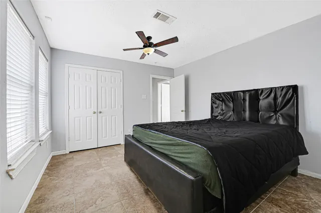 a bedroom with a bed and window