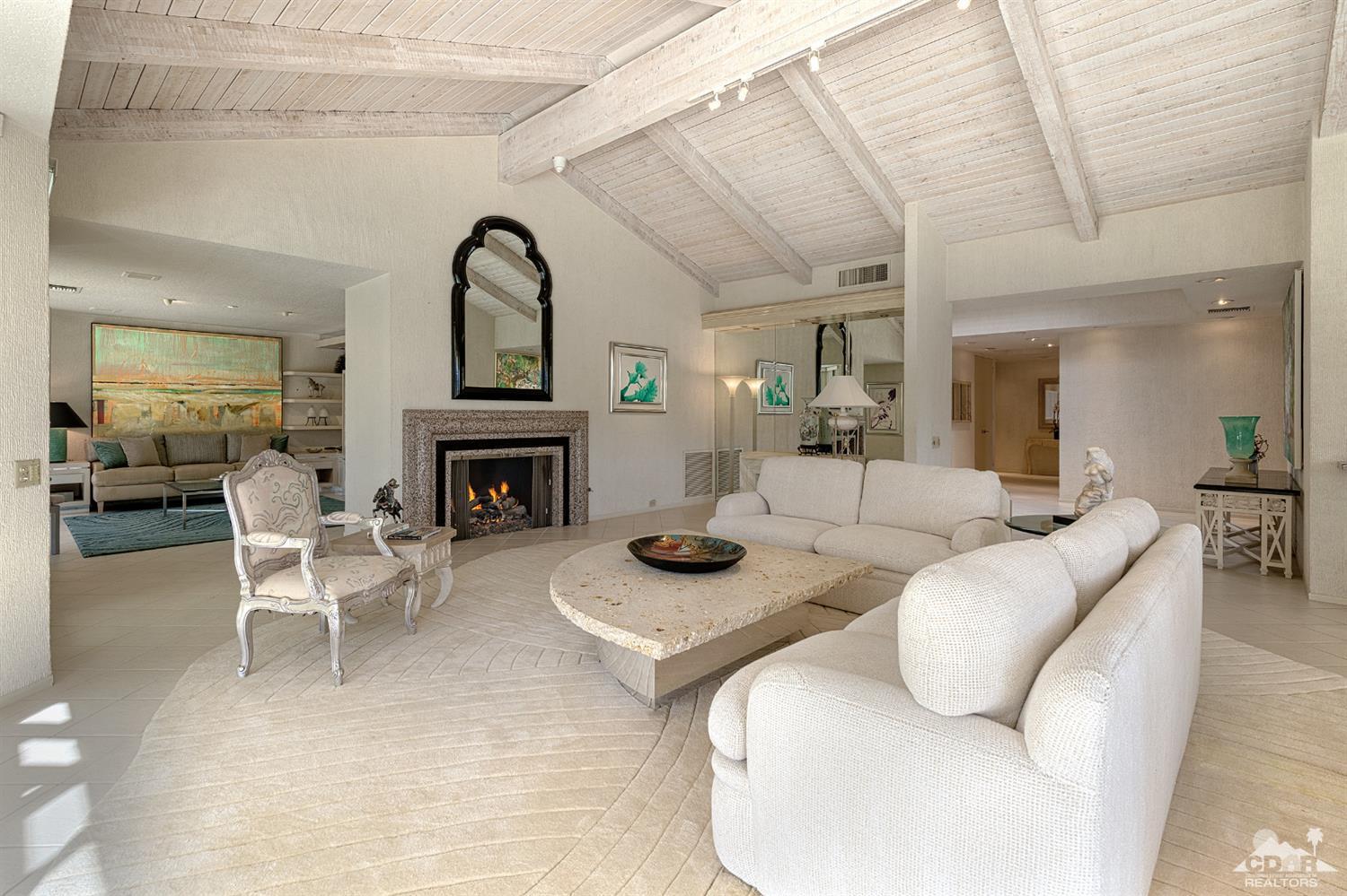 24 Johnar Boulevard Rancho Mirage, CA 92270 - Photo 11 of 26 a living room with furniture a fireplace and a dining table