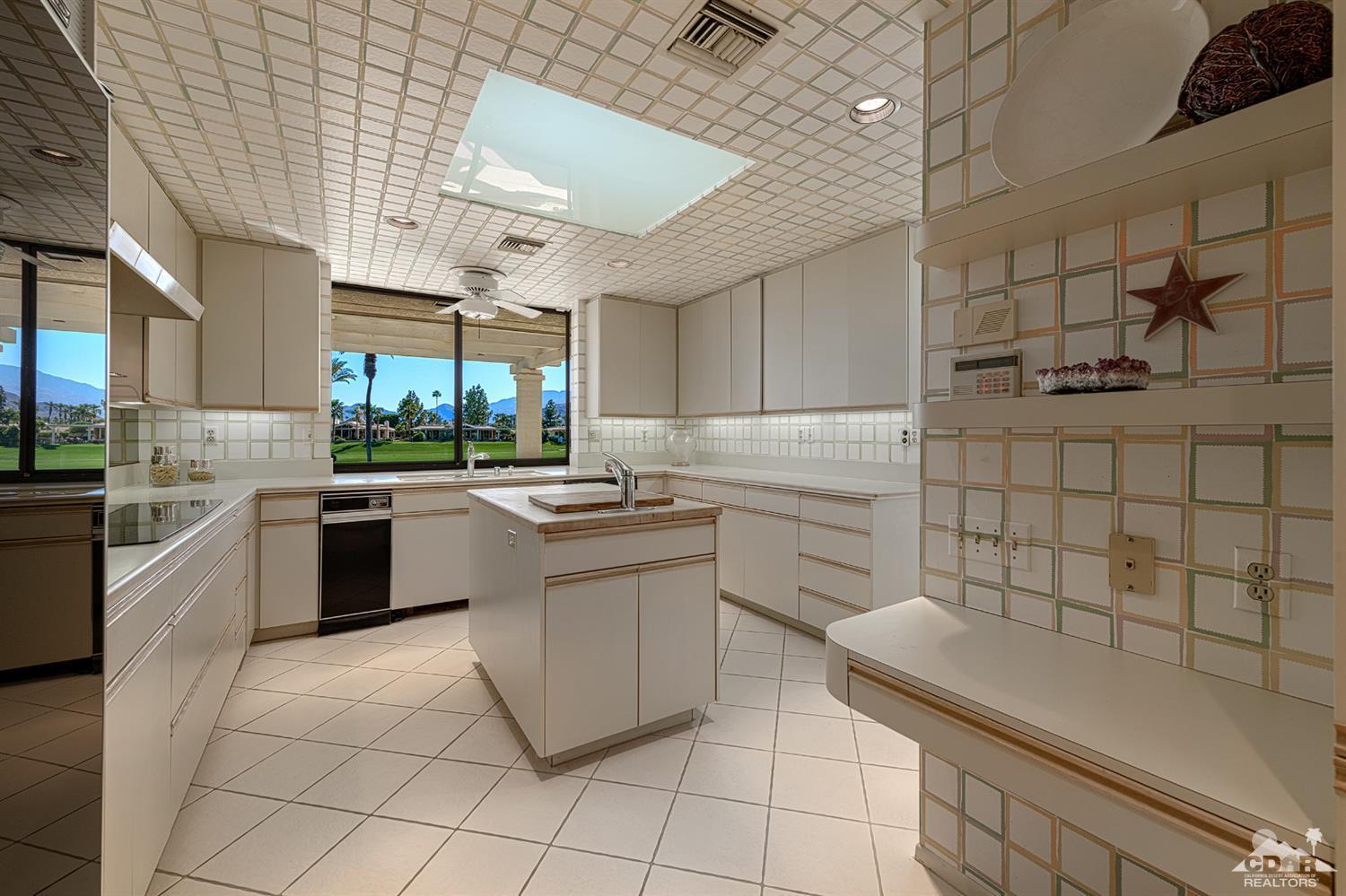 24 Johnar Boulevard Rancho Mirage, CA 92270 - Photo 12 of 26 a kitchen with stainless steel appliances kitchen island granite countertop a sink and cabinets