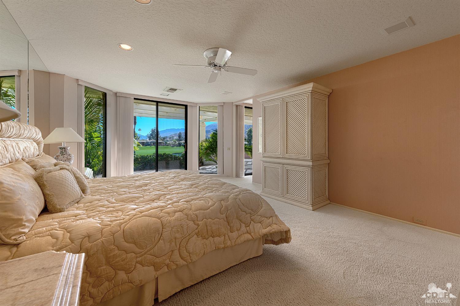 24 Johnar Boulevard Rancho Mirage, CA 92270 - Photo 13 of 26 a bedroom with a large bed and a large window