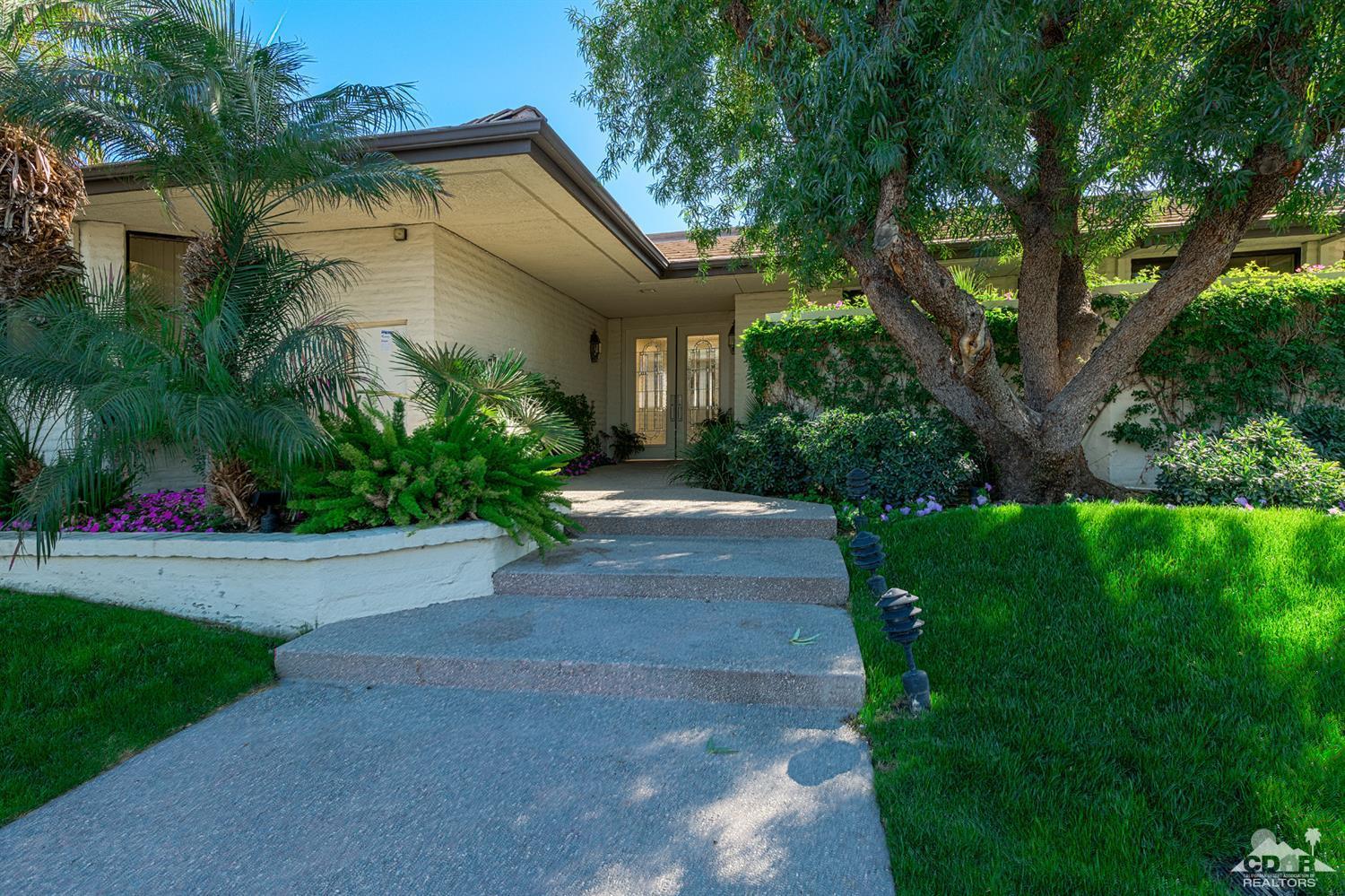24 Johnar Boulevard Rancho Mirage, CA 92270 - Photo 25 of 26 a front view of a house with a yard and trees