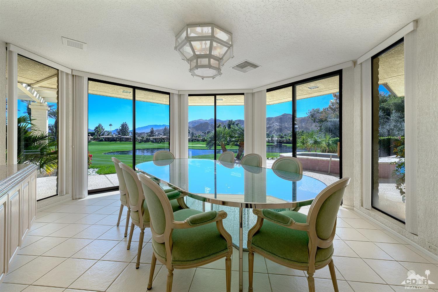 24 Johnar Boulevard Rancho Mirage, CA 92270 - Photo 8 of 26 a view of a dining room with furniture large windows and wooden floor