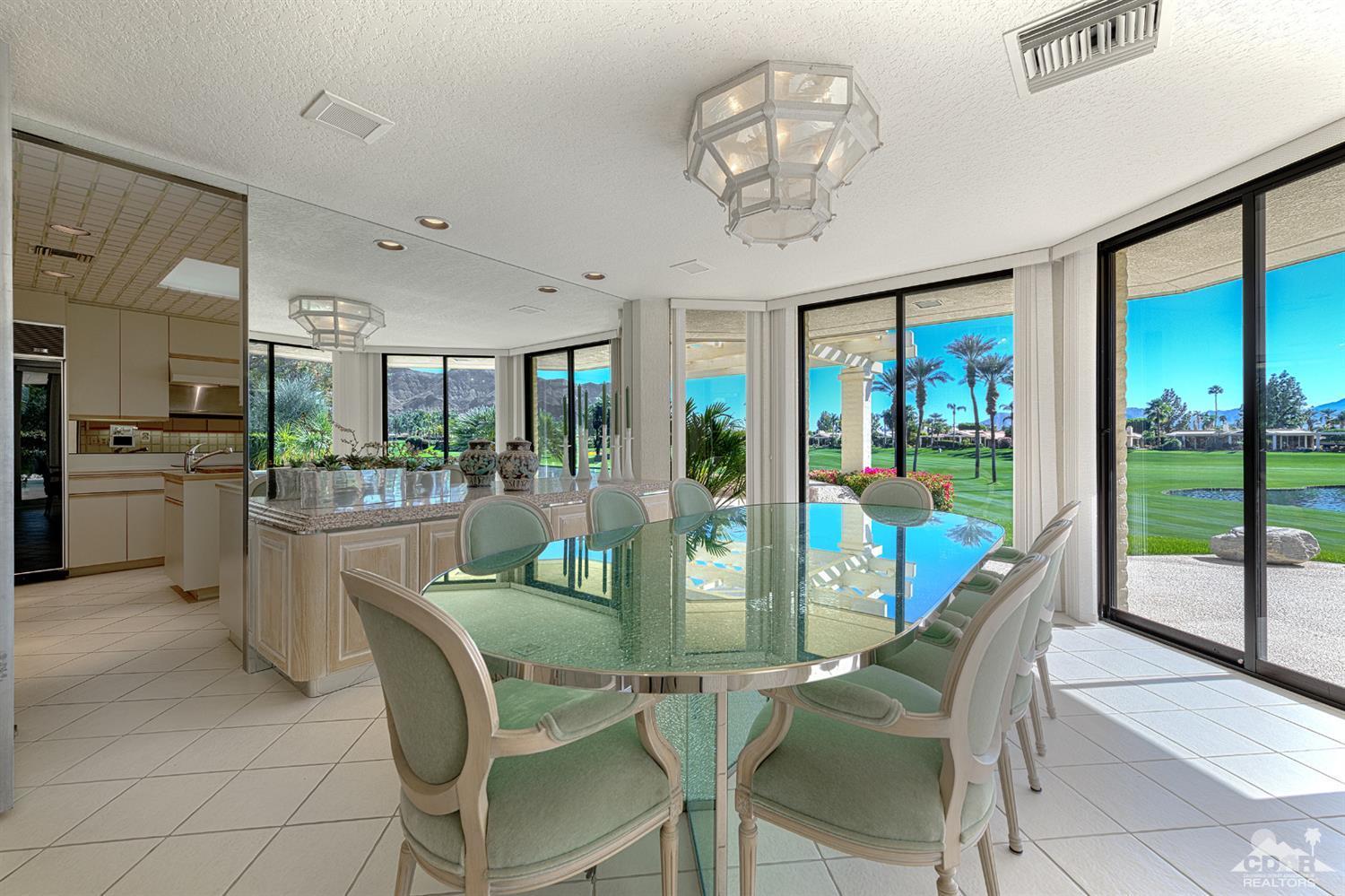 24 Johnar Boulevard Rancho Mirage, CA 92270 - Photo 9 of 26 a dining room with furniture a chandelier and fireplace