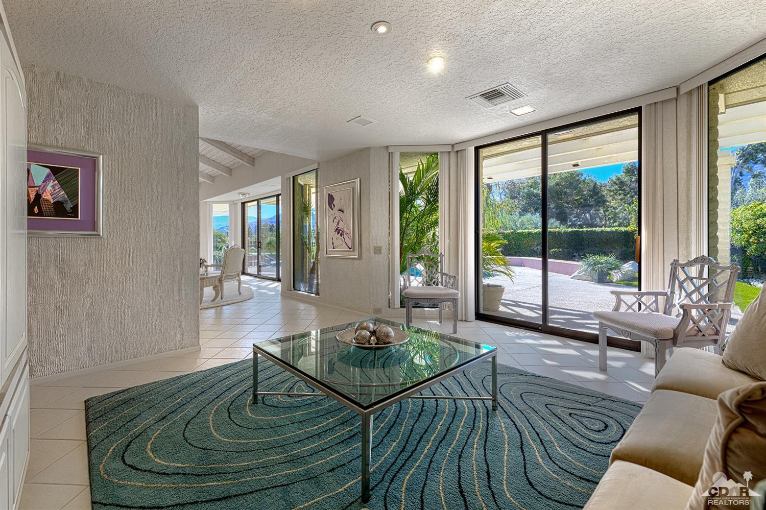 24 Johnar Boulevard Rancho Mirage, CA 92270 - Photo 10 of 26 a living room with furniture and a floor to ceiling window