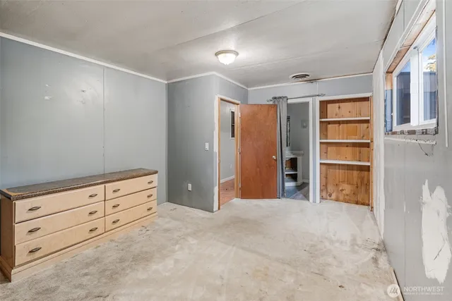 a view of an empty room with cabinet and stairs