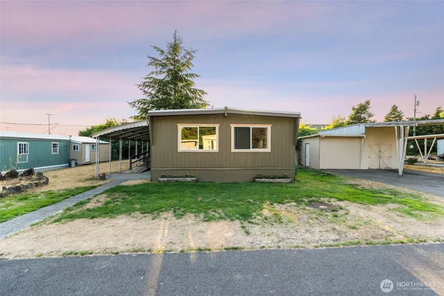 a front view of a house with a yard and a garage