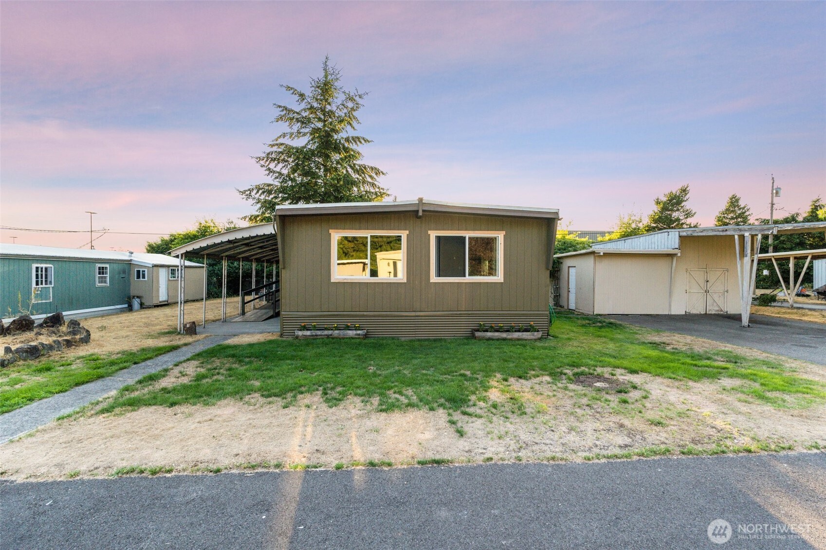 8510 Martin Way East, Unit 25 Lacey, WA 98516 - Photo 18 of 26 a front view of a house with a yard and a garage