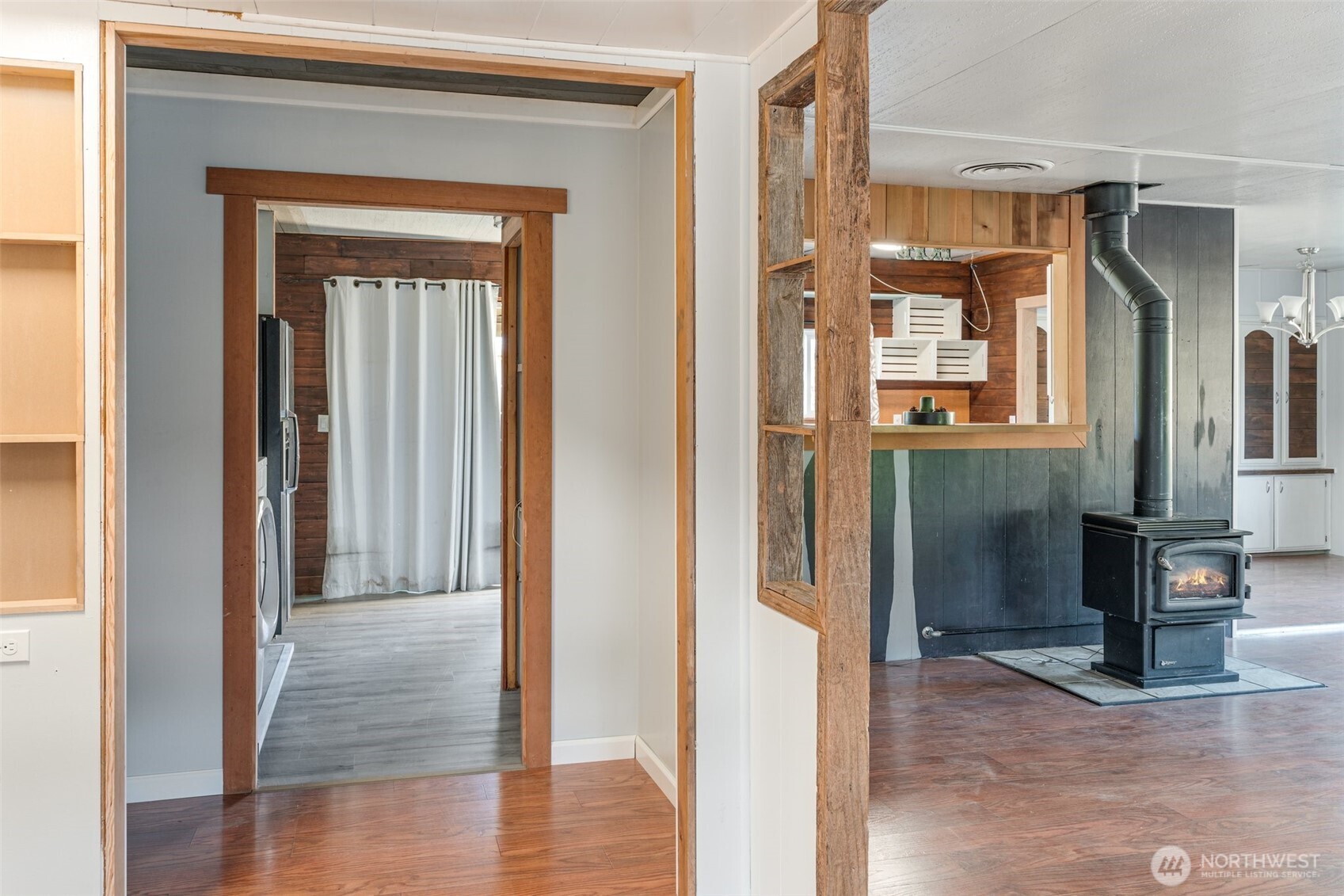 8510 Martin Way East, Unit 25 Lacey, WA 98516 - Photo 2 of 26 a view of a hallway with wooden floor and a cabinet