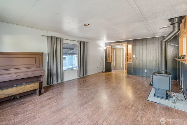 a view of an empty room and wooden floor