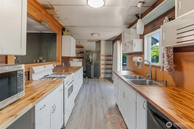 a kitchen with stainless steel appliances granite countertop a lot of counter space