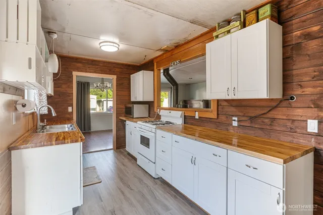 a kitchen with sink stove and cabinets