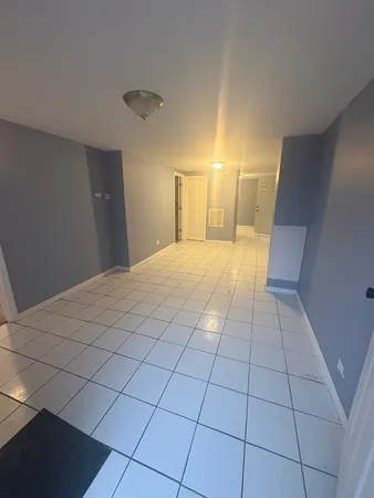 a view of a livingroom with an empty space and a window