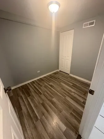 a view of a room with wooden floor and staircase