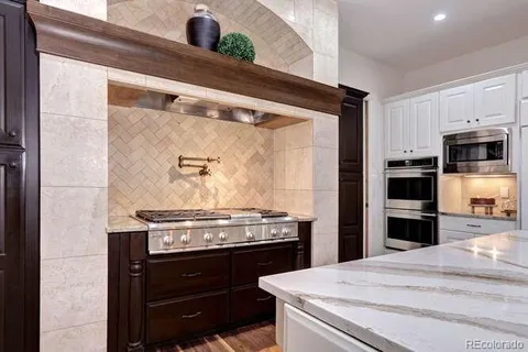 a kitchen with stainless steel appliances a stove and a refrigerator