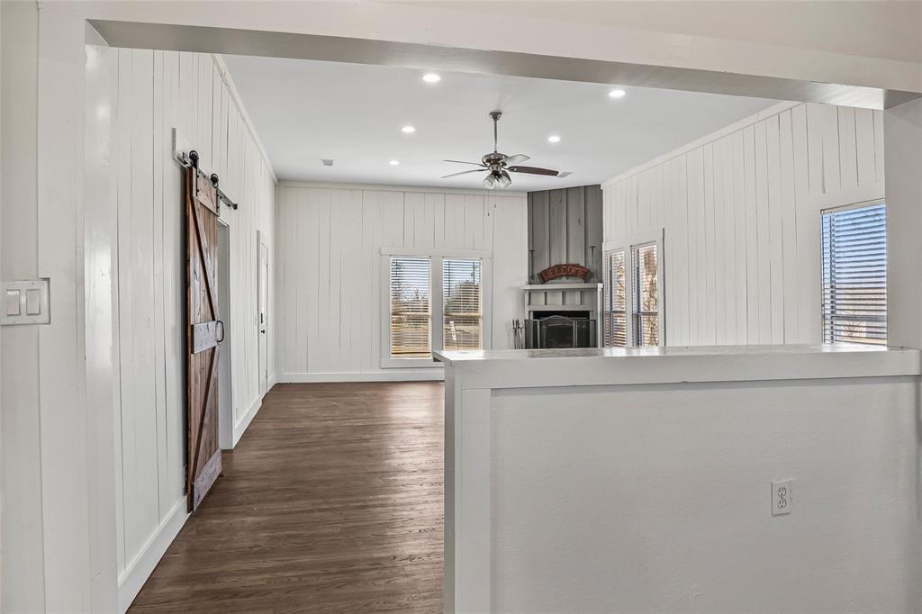 442 West McCart Street Krum, TX 76249 - Photo 14 of 40 wooden floor in an empty room with a window