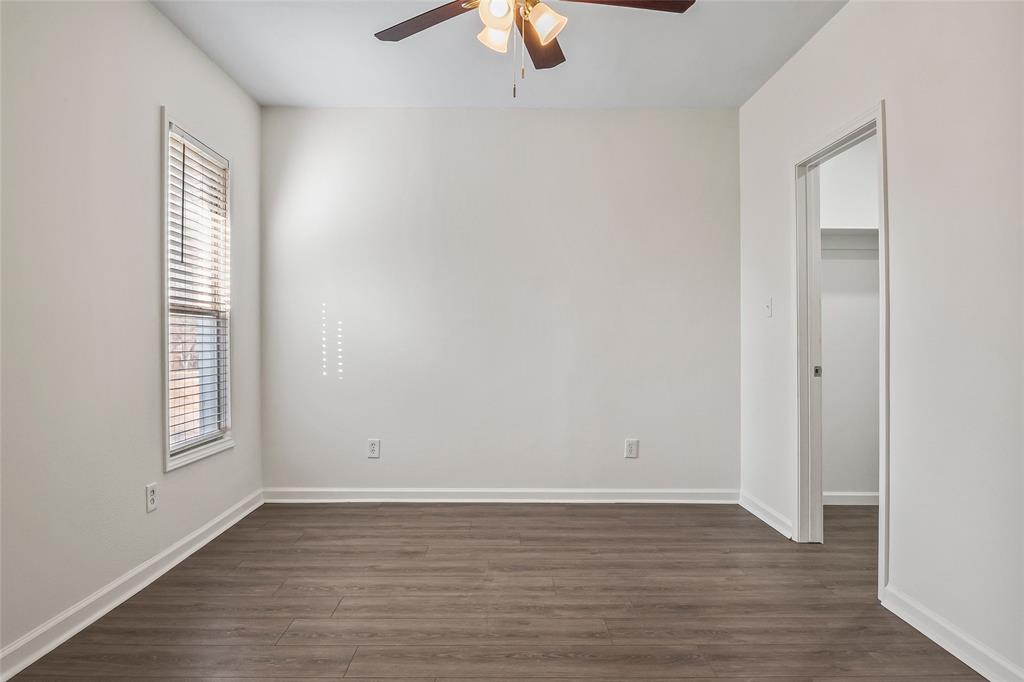 442 West McCart Street Krum, TX 76249 - Photo 16 of 40 wooden floor in an empty room with a window