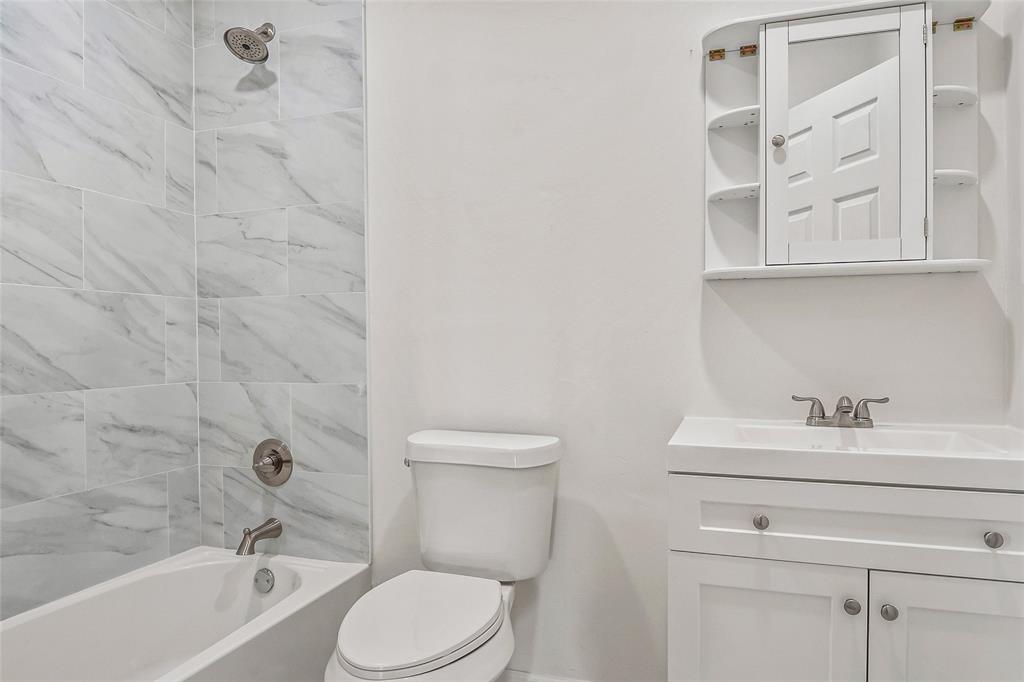 442 West McCart Street Krum, TX 76249 - Photo 18 of 40 a bathroom with a sink a toilet and shower