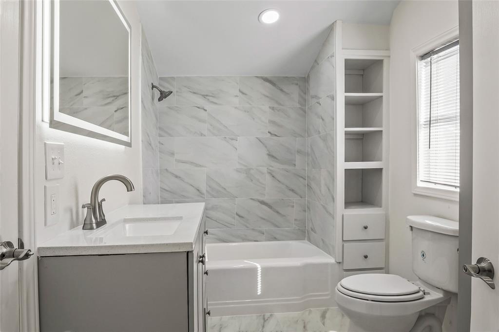 442 West McCart Street Krum, TX 76249 - Photo 23 of 40 a bathroom with a sink toilet and shower