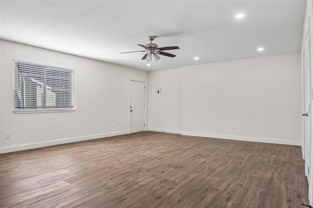 442 West McCart Street Krum, TX 76249 - Photo 28 of 40 wooden floor in an empty room with a window