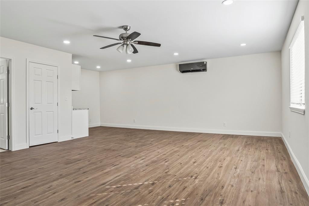 442 West McCart Street Krum, TX 76249 - Photo 29 of 40 wooden floor in an empty room with a window