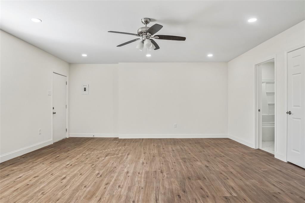 442 West McCart Street Krum, TX 76249 - Photo 31 of 40 an empty room with wooden floor and windows