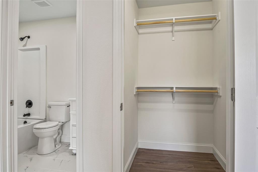 442 West McCart Street Krum, TX 76249 - Photo 34 of 40 a bathroom with a toilet and a shower