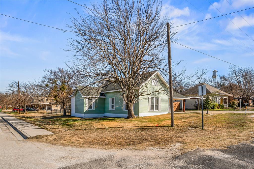 442 West McCart Street Krum, TX 76249 - Photo 39 of 40 a house with trees in front of it