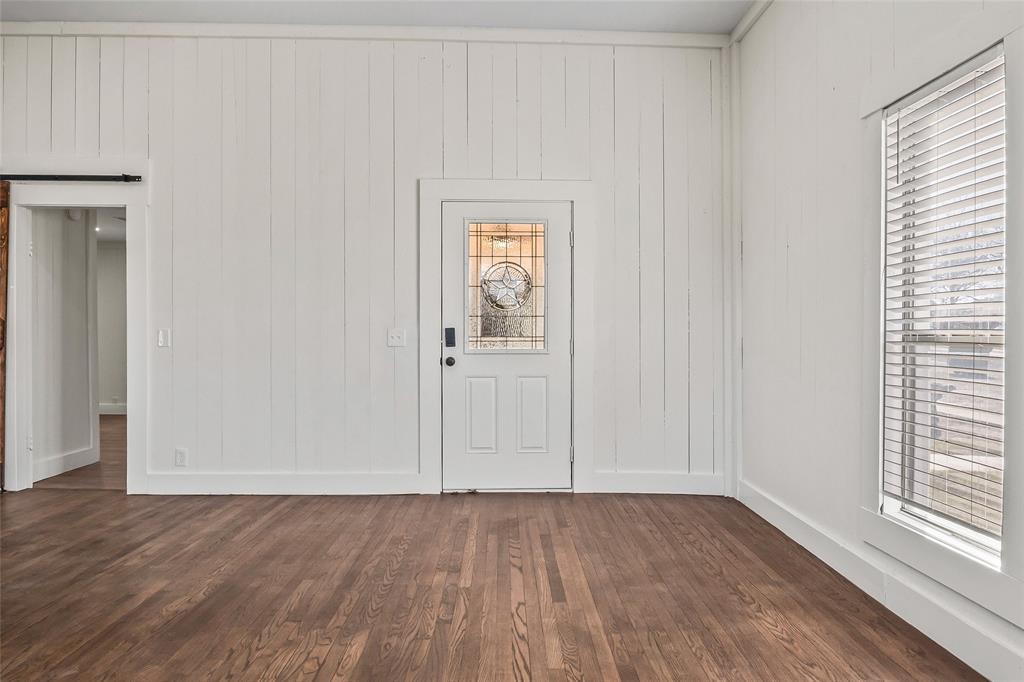 442 West McCart Street Krum, TX 76249 - Photo 5 of 40 an empty room with wooden floor and windows