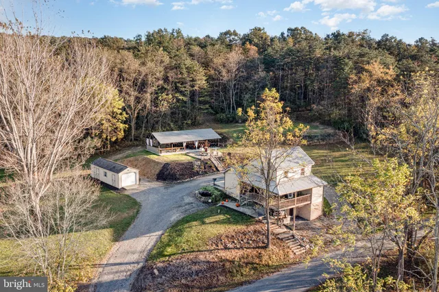 an aerial view of a house with yard swimming pool and outdoor seating