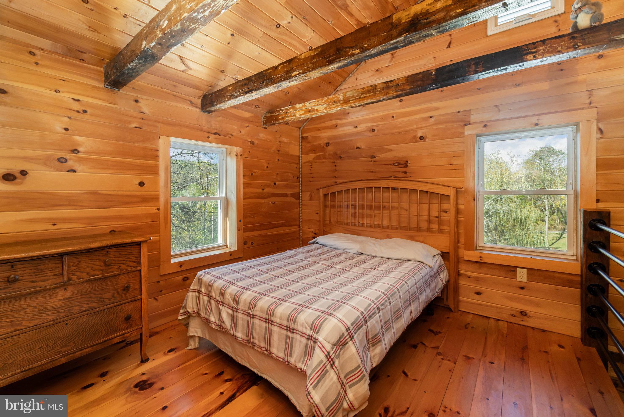 1180 Campbell Hollow Road East Waterford, PA 17021 - Photo 11 of 51 a bed sitting in a bedroom next to a window
