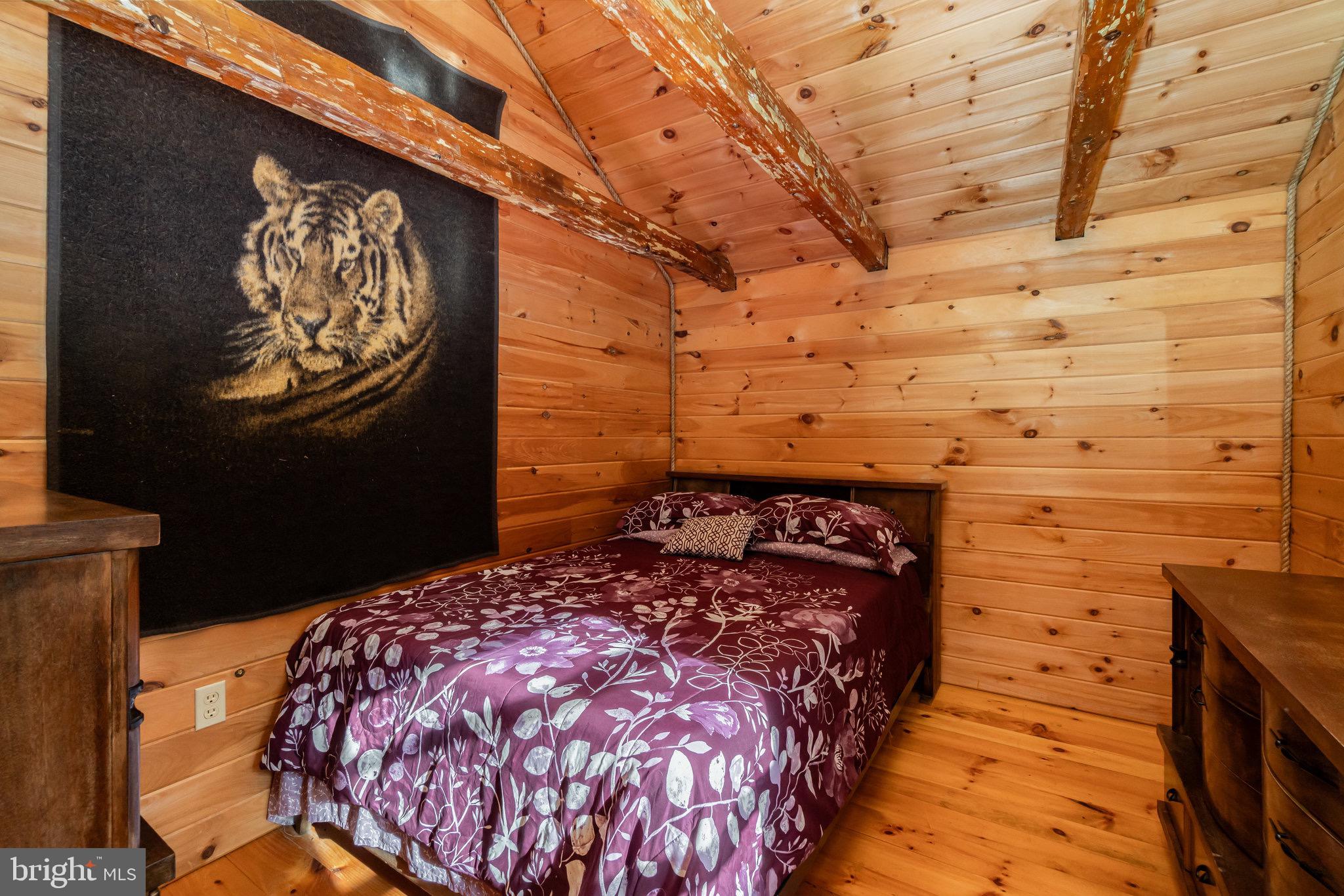 1180 Campbell Hollow Road East Waterford, PA 17021 - Photo 13 of 51 a bed sitting in a bedroom next to a building