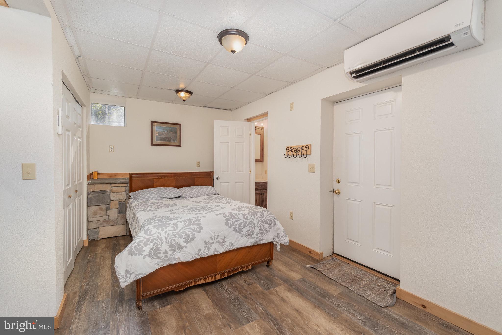 1180 Campbell Hollow Road East Waterford, PA 17021 - Photo 16 of 51 a bedroom with a bed and wooden floor