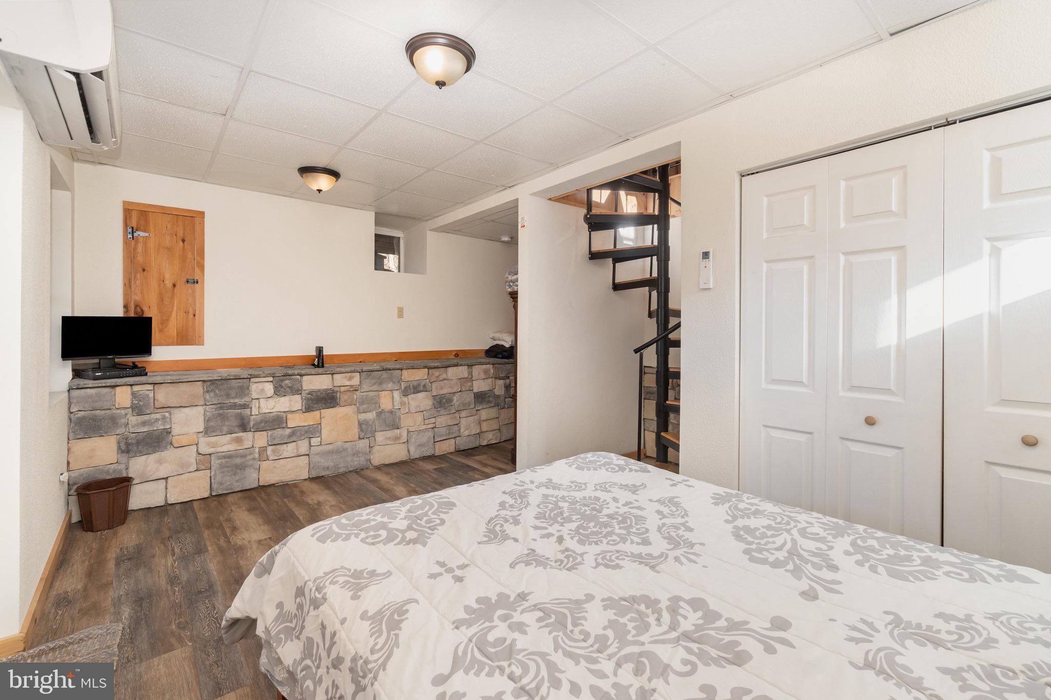 1180 Campbell Hollow Road East Waterford, PA 17021 - Photo 17 of 51 a bedroom with a bed and a flat screen tv