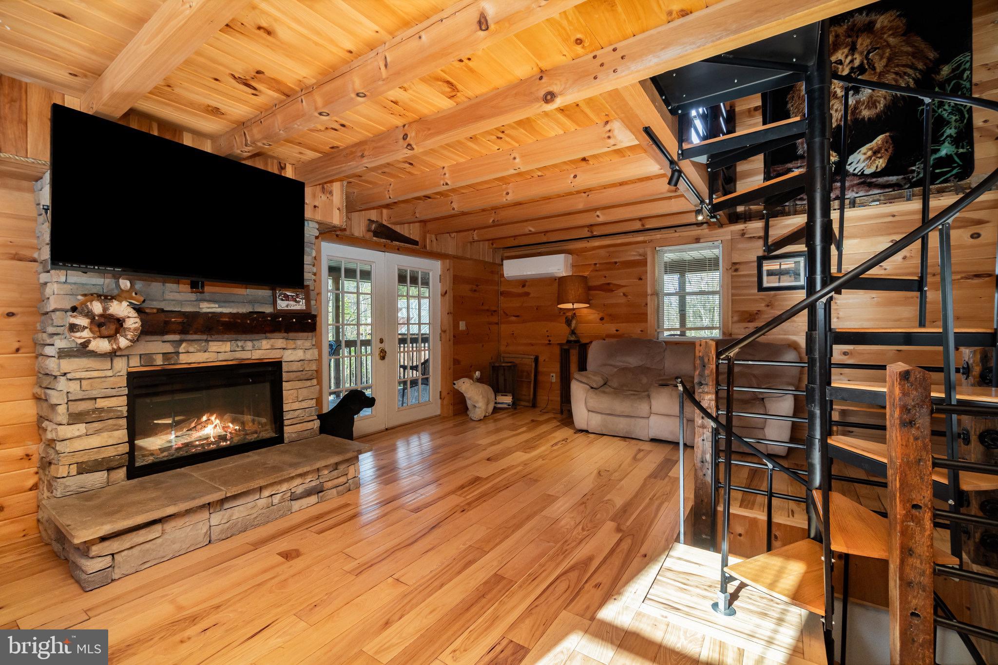 1180 Campbell Hollow Road East Waterford, PA 17021 - Photo 2 of 51 a living room with furniture a flat screen tv and a fireplace