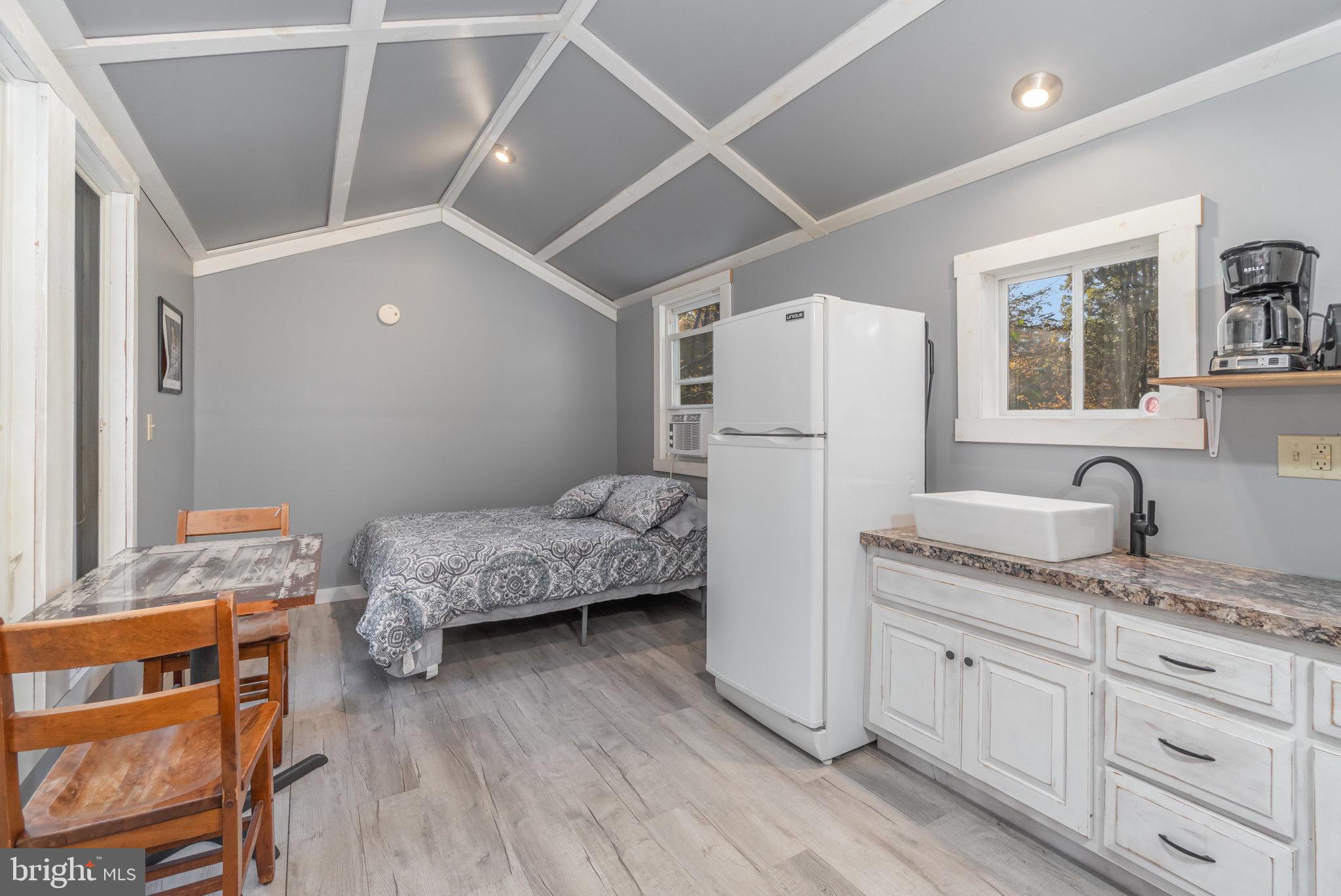 1180 Campbell Hollow Road East Waterford, PA 17021 - Photo 21 of 51 a bedroom with a bed and a refrigerator