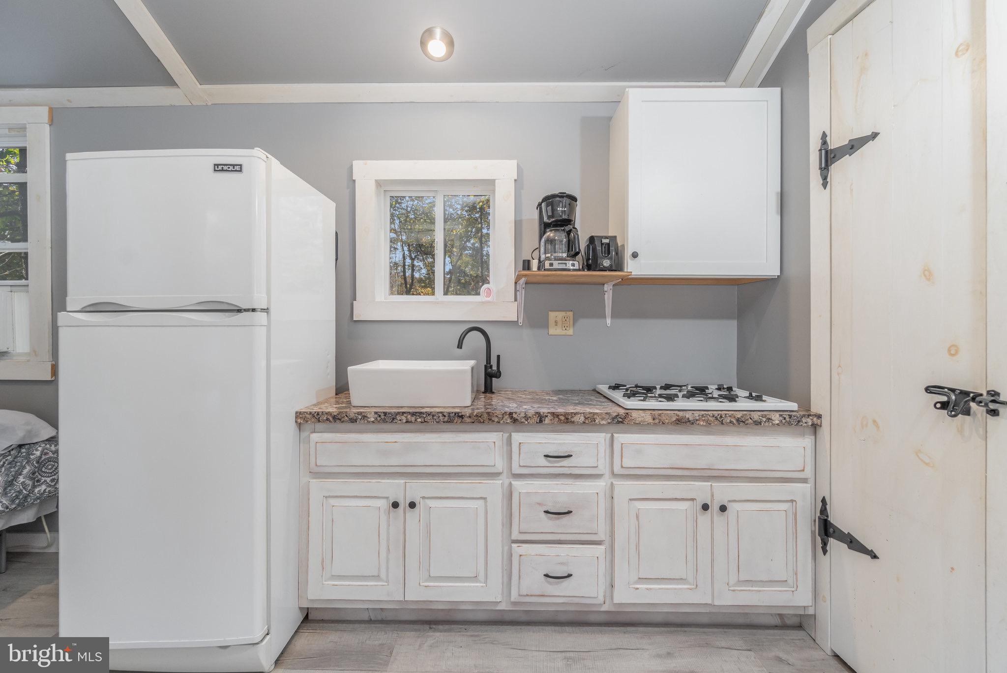1180 Campbell Hollow Road East Waterford, PA 17021 - Photo 22 of 51 a kitchen with white cabinets and white appliances