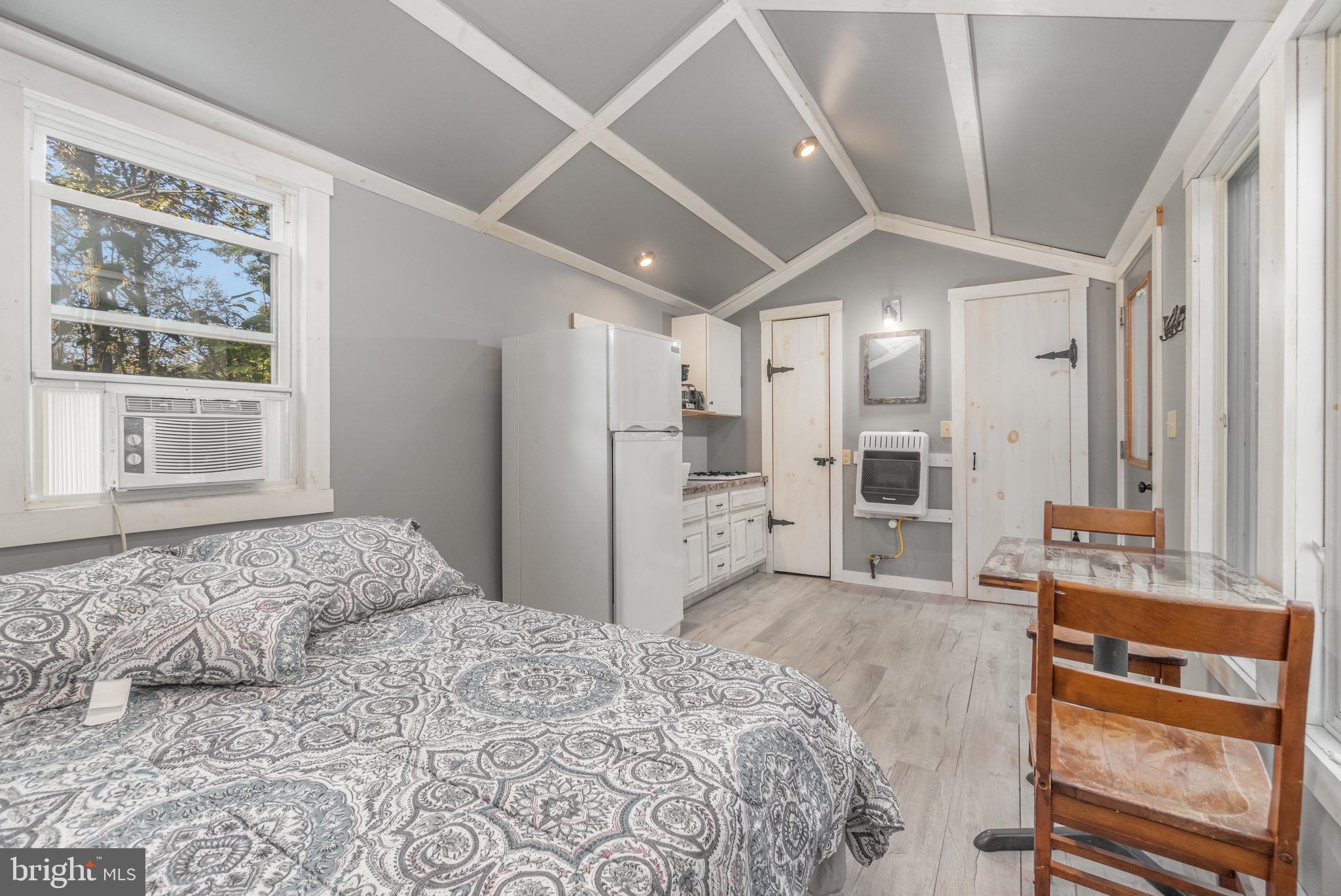 1180 Campbell Hollow Road East Waterford, PA 17021 - Photo 24 of 51 a bedroom with a bed and a large window