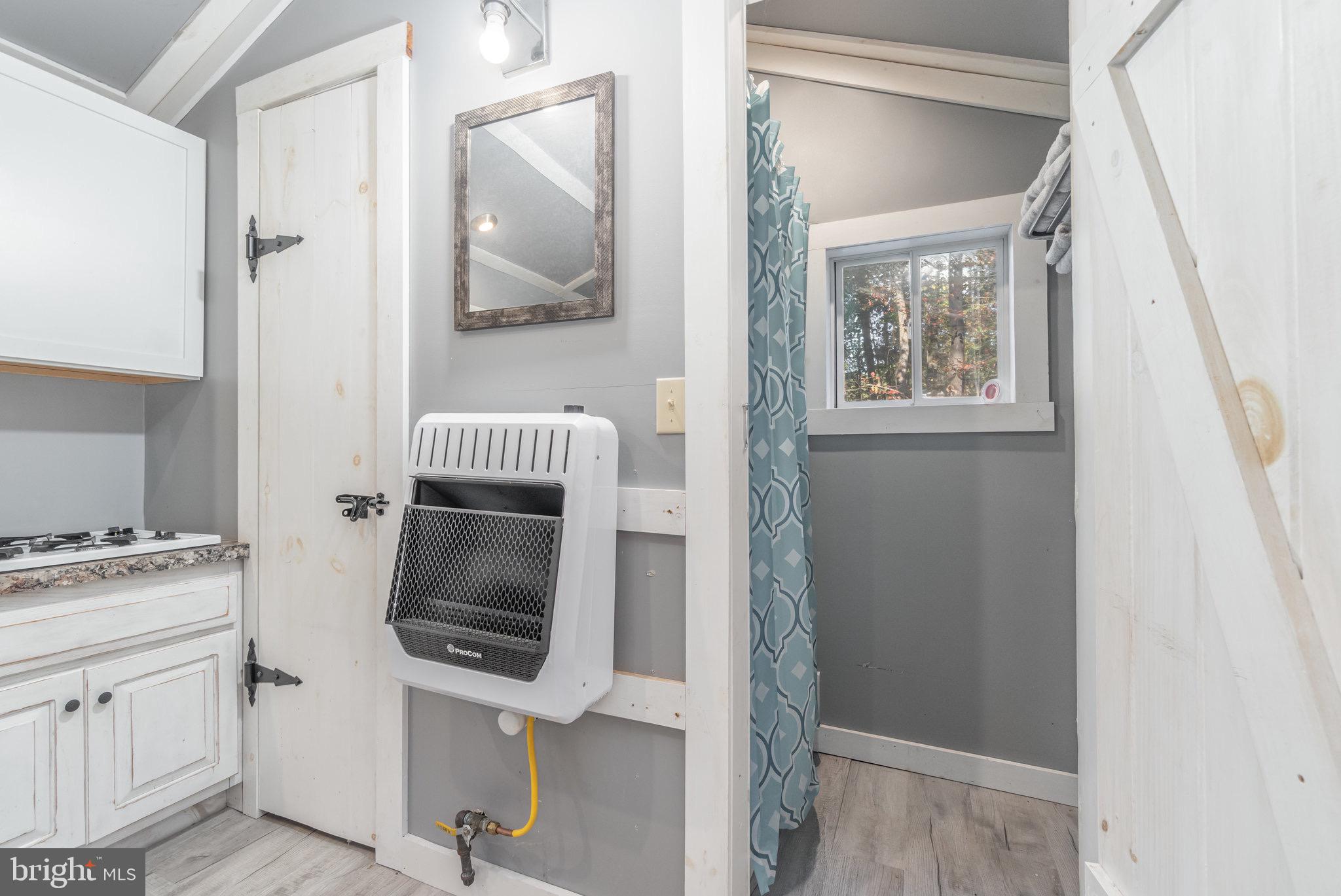 1180 Campbell Hollow Road East Waterford, PA 17021 - Photo 25 of 51 a room with a window and a mirror