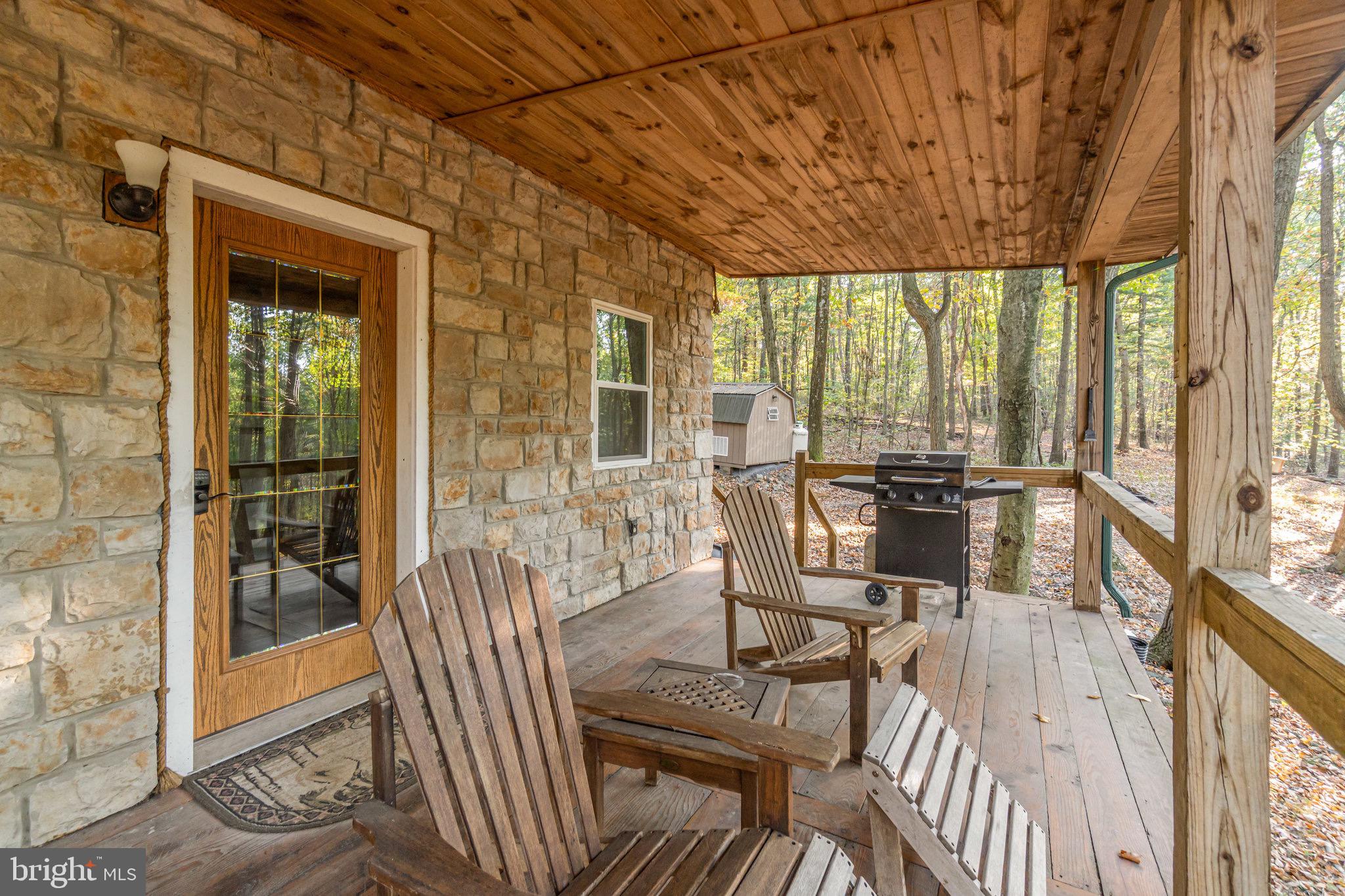 1180 Campbell Hollow Road East Waterford, PA 17021 - Photo 28 of 51 a view of a dining room with furniture large windows and wooden floor
