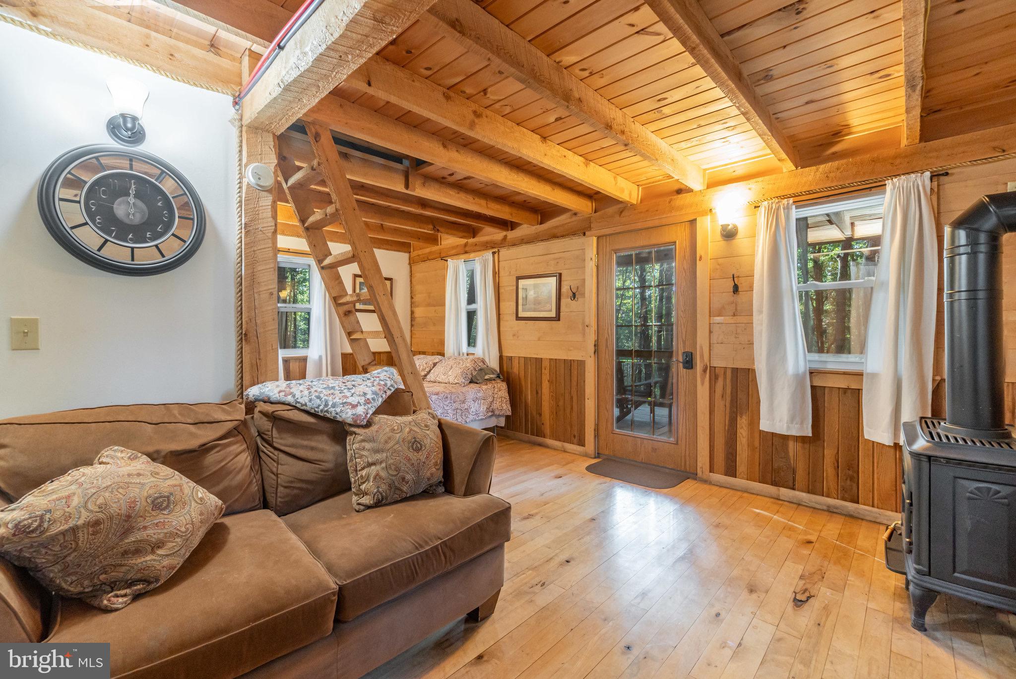 1180 Campbell Hollow Road East Waterford, PA 17021 - Photo 29 of 51 a living room with furniture a rug and a large window