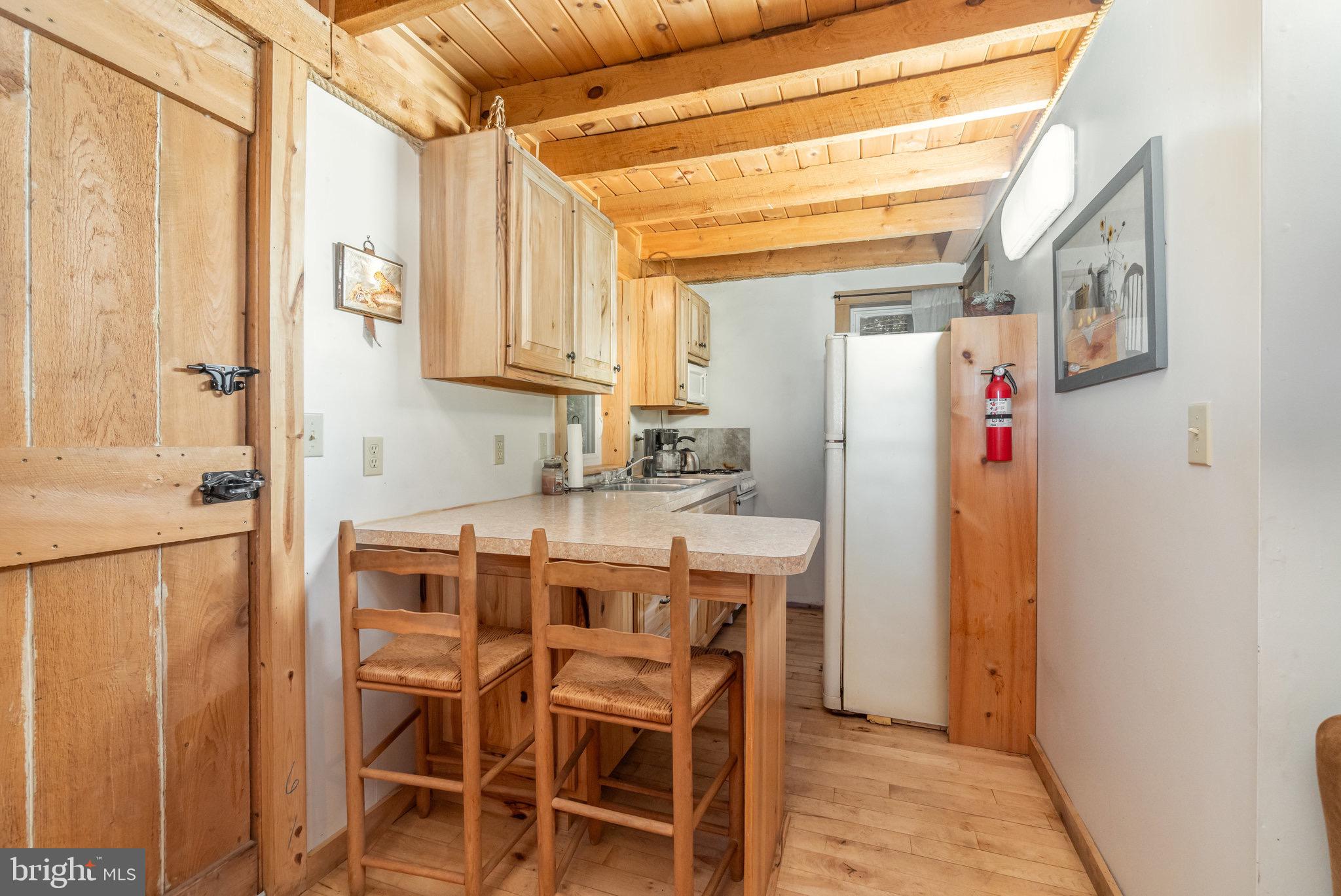 1180 Campbell Hollow Road East Waterford, PA 17021 - Photo 31 of 51 a kitchen with stainless steel appliances granite countertop a refrigerator and a sink