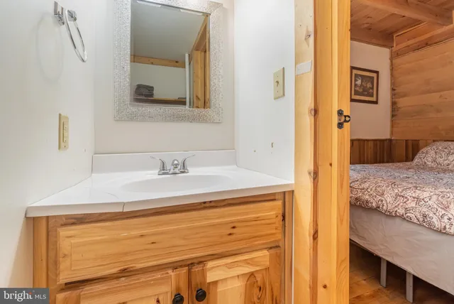 a bed sitting in a spacious bedroom next to a window