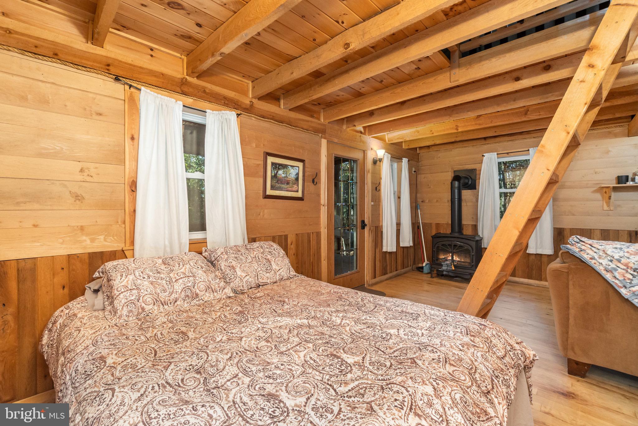 1180 Campbell Hollow Road East Waterford, PA 17021 - Photo 35 of 51 a bed sitting in a spacious bedroom next to a window