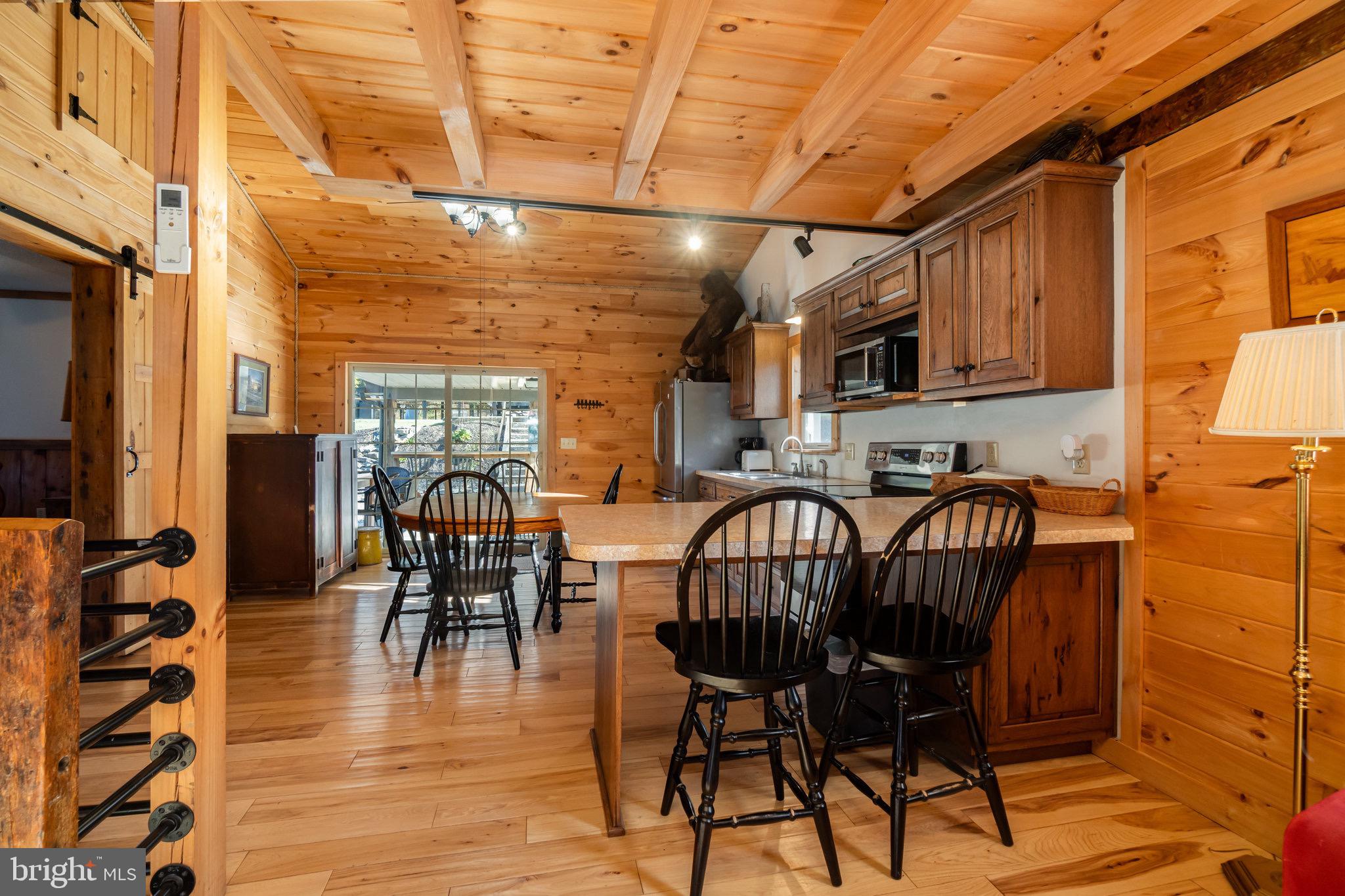 1180 Campbell Hollow Road East Waterford, PA 17021 - Photo 5 of 51 a view of a dining room with furniture window and wooden floor